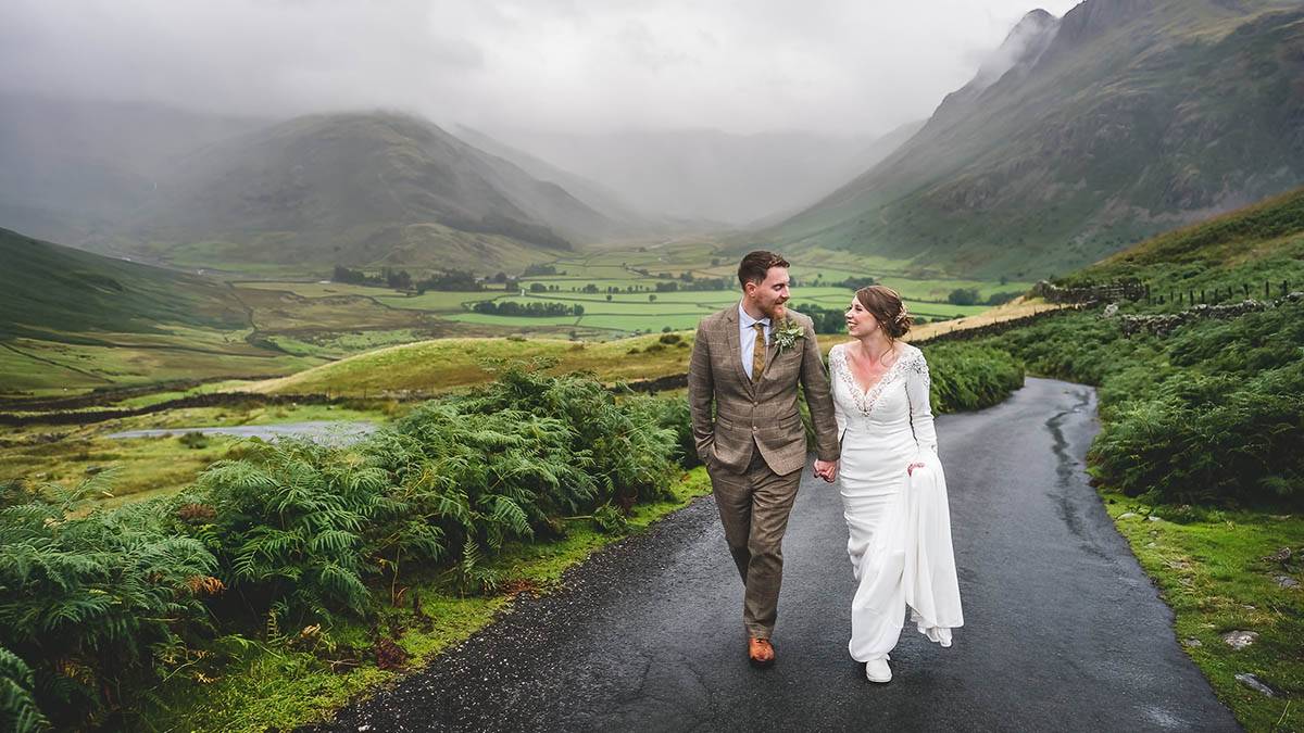 Couple walking on the road at Langdale Lake District wedding photographers Couple walking on the road at Langdale Lake District wedding photographers