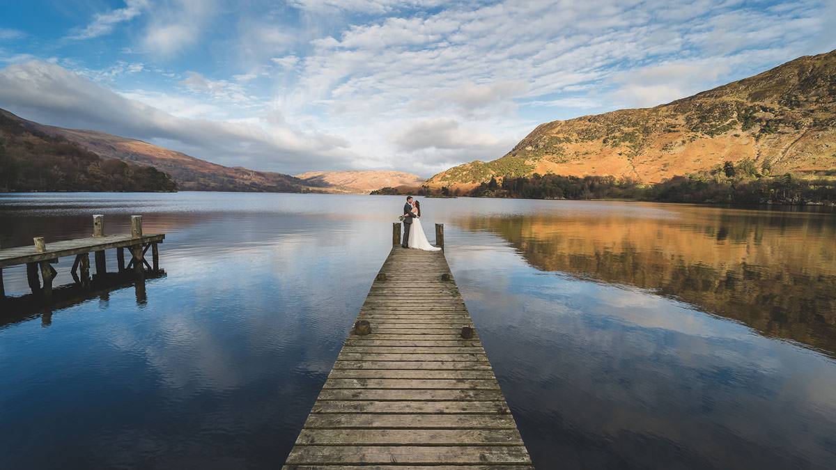 wedding photographers in the lake district couple of the jetty at Inn on the Lake wedding photographers in the lake district couple of the jetty at Inn on the Lake